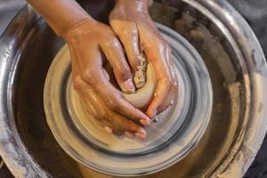 Hands shaping pottery photo
