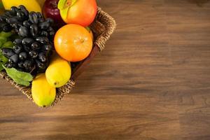 Vegetable for making salad and fruits in basket on table photo