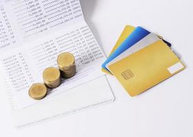 Credit card and money coins stack on book bank for loan money concept photo