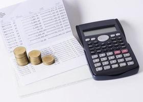 Money coins stack and calculator and book baank loan money concept photo