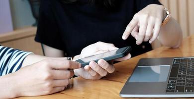 Group of friends having fun together with smartphones - Closeup of hands social networking with mobile cellphones. photo