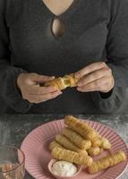 Woman opening a tequeno photo