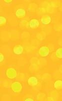 Yellow abstract blurred background with bokeh effect vector
