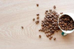 Closeup top view of many coffee beans in a ceramic mug with copy space for adding some text photo