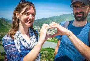 Couple putting hands together in a heart shape photo