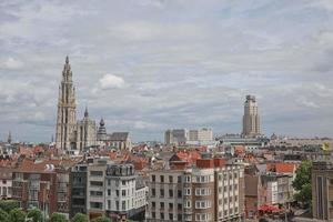 Cityscape of a port of Antwerp and cathedral of our lady in Belgium over the river photo