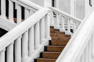 Stone steps of an old house with white railing close up photo