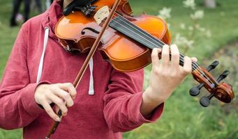 Hands of a street musician girl with violin photo