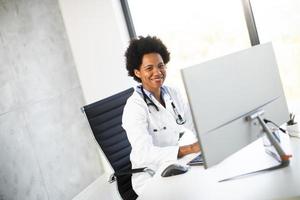 Doctor smiling at computer photo