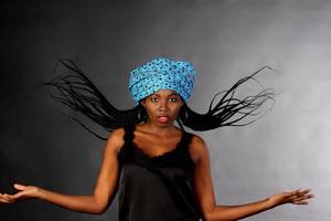 Woman in blue headscarf with hair flipped photo