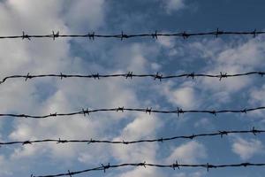 Barbed wire against a blue sky photo