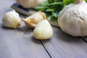 Garlic and parsley on cutting board photo