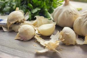 Garlic cloves on wooden table photo