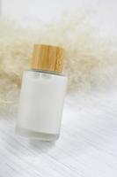 Cosmetic cream bottle with wooden top photo