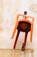 Orange chair hanging on the wall of a traditional house in the old city of Nicosia, Cyprus photo