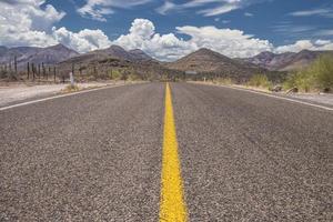 Close up image of the road with mountains and clouds on the sky bottom view desert of Baja California, Mexico photo