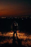 Young couple a guy and a girl in bright knitted hats stopped at a camping photo