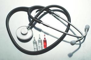 A traditional stethoscope and three vaccination tubes photo