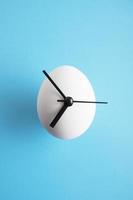 An egg clock on blue background photo