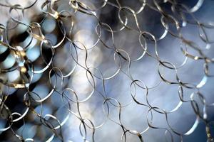 Close up image of a metal net with colorful abstract background photo
