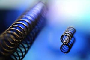 Close up image of metal springs on blue background photo