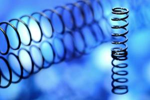 Close up image of metal springs on blue background photo