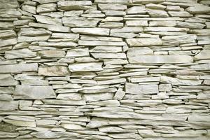 Wall background with rough stone layer