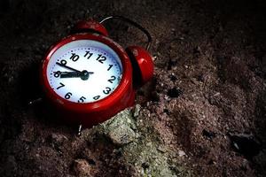 A red alarm clock under the bright spotlight photo