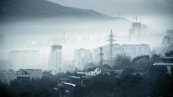 Heavily polluted city in blue monochrome
