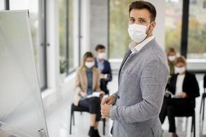 Masked speaker in front of crowd photo