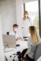 Doctors meeting with patient with masks on
