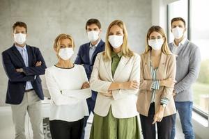 Professionals standing and wearing masks photo