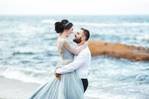 Same couple with a bride in a blue dress walk photo