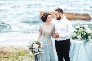 Same couple with a bride in a blue dress walk photo