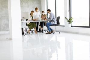 Masked people in a meeting with copy space photo