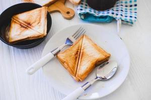 Roasted toast bread popping up of a stainless steel toaster in a home kitchen. photo