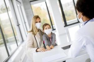 Child and parent talking to a doctor photo