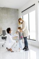 Mother and daughter talking to a pediatrician photo