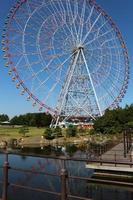 Ferris wheel at the amusement park with blue sky photo