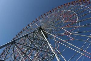 Ferris wheel with blue sky at the amusement park photo