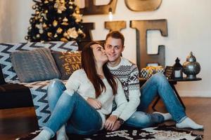 Guy and a girl celebrate the new year together and give each other gifts photo