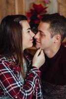 Guy and a girl celebrate the new year together and give each other gifts photo