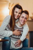 Guy and a girl celebrate the new year together and give each other gifts photo