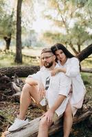 Young couple in love a guy with a beard and a girl with dark hair in light clothes photo