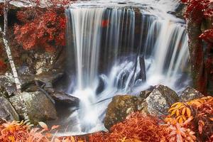 Autumn waterfall in deep forest photo