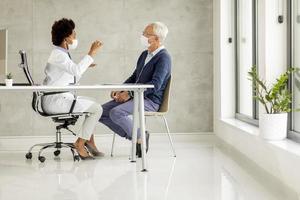 Doctor and mature male patient with masks on photo