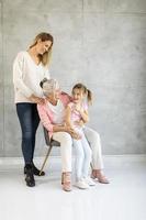 Three generations of women on a gray background