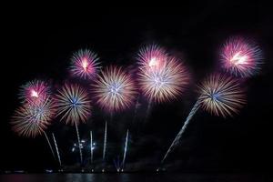 Festive beautiful colorful fireworks display on the sea beach   Amazing holiday fireworks party or any celebration event in the dark sky photo