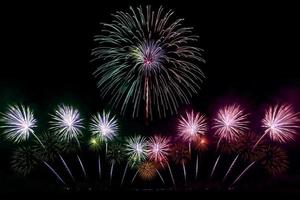 Festive beautiful colorful fireworks display on the sea beach Amazing holiday fireworks party or any celebration event in the dark sky photo