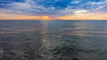 Seascape with sunset and dark sea photo